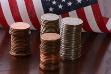 Piles Of Coins With American Flag