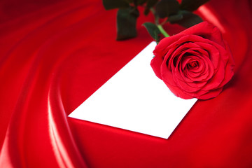 Wall Mural - Envelope and red rose over silk background