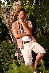 Wall Mural - Young man meditating in the green