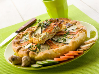 Wall Mural - vegetables cake over dish on green background