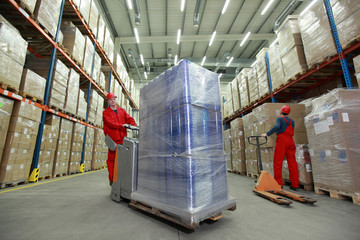 warehousing - workers in uniforms  working in storehouse