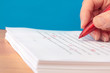 © Pixsooz - Hand with Red Pen Proofreading a Manuscript Closeup