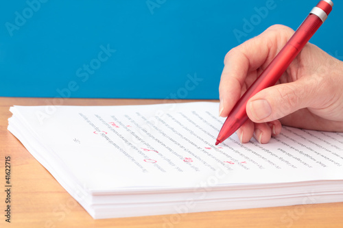 Hand with Pen Proofreading a Manuscript