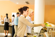 © CandyBox Images - Young business colleagues select canteen lunch