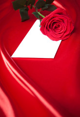 Wall Mural - Envelope and red rose over silk background