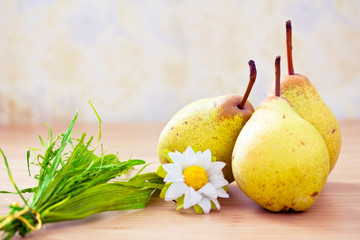 pears on dinner table with daisy