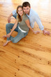 © goodluz - Couple at home relaxing on the floor