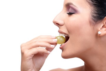 Sticker - Closeup profile of young woman eating grapes