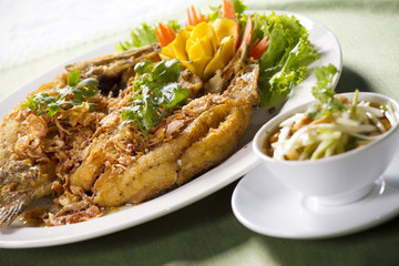 Wall Mural - fried fish, crisp-fried with fish hot and sour mango salad