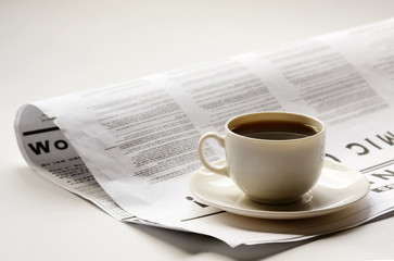 Coffee cup and newspaper