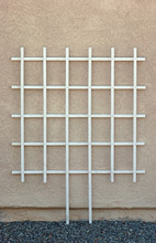Empty White Wooden Trellis Against Stucco Wall