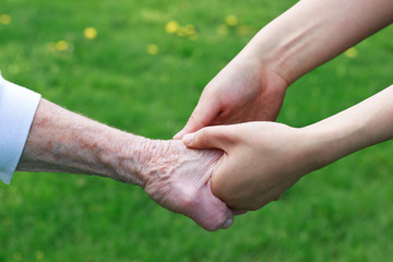 Wall Mural - Senior and Young Women Holding Hands