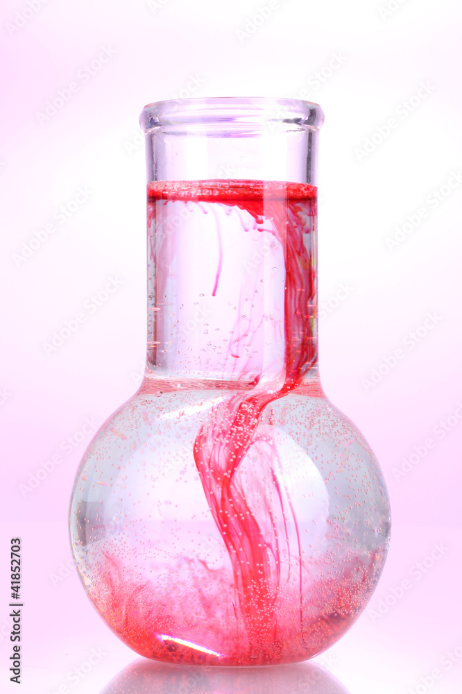 brightly ink in a flask with water isolated on white