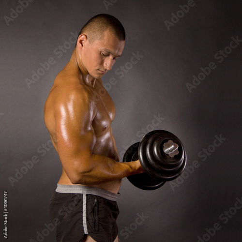 Muscled Male Bodybuilder Dumbbell Swing Buy This Stock