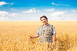 © Ryzhkov Oleksandr - farmer standing in a wheat field