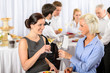 © CandyBox Images - Business meeting two women celebrate champagne