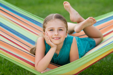 Wall Mural - Summer in the garden - lovely girl in colorful hammock