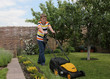 © Denizo - Teen boy mows the lawn mower electric