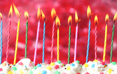 Poster - beautiful birthday candles  on red background