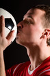 © Sergey Peterman - soccer player is kissing the ball