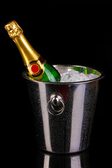 Wall Mural - Bottle of champagne in bucket isolated on black