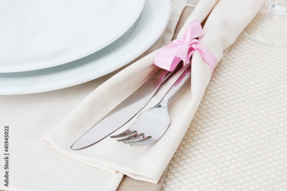 Table setting with fork, knife, plates, and napkin