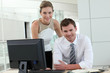 © goodluz - Business people meeting in office in front of desktop