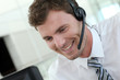 © goodluz - Portrait of salesman with headset on