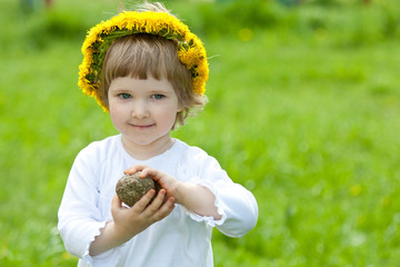 Smiling little girl in yellow chaplet