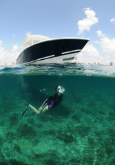 Wall Mural - fit young woman snorkeling underwater