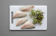 Fish with herbs on the chopping board