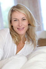 Portrait of blond mature woman relaxing in sofa