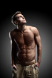 © ASDF - portrait of young strong man against black