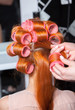 Closeup of red hair during hair dressing with curler