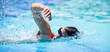 © lightpoet - Young man swimming the front crawl in a pool
