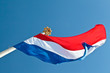 Dutch flag with a crown on top of the flagpole