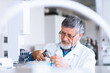 © lightpoet - senior male researcher carrying out scientific research in a lab