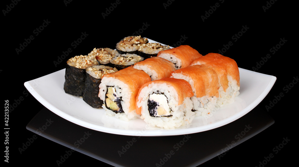 Tasty rolls served on white plate isolated on black