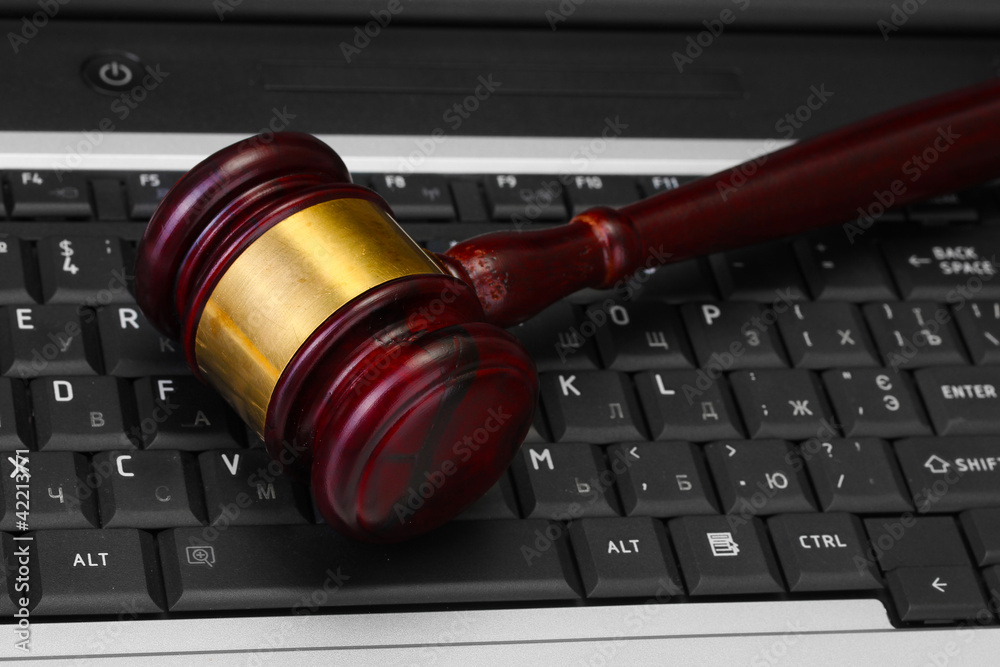 wooden gavel on laptop computer close up