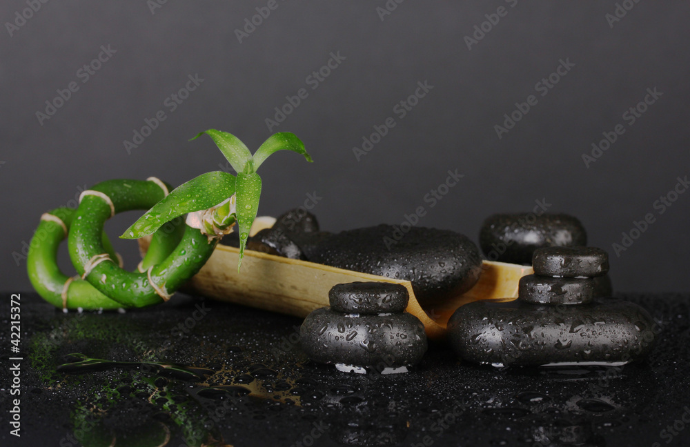 Composition of bamboo and spa stones isolated on black