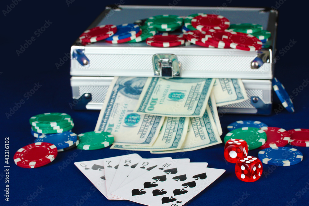Suitcase with dollars on the blue poker table