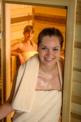 Wall Mural - Two women at sauna wrapped in towel