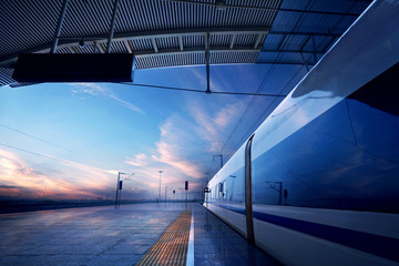 Wall Mural - train stop at railway station with sunset