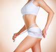 Woman measuring her waistline. Diet. Perfect Slim Body
