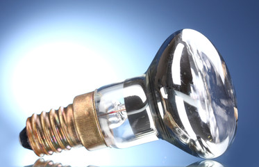 Light bulb on blue background