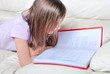 © Heliosphile - Girl student on the couch with a notebook
