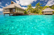 Over water bungalows with steps into blue lagoon