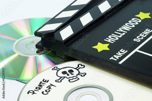 Fotografering Pirate Copy written on a dvd next to a clapper board
