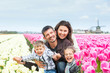 Family having fun on tulips field