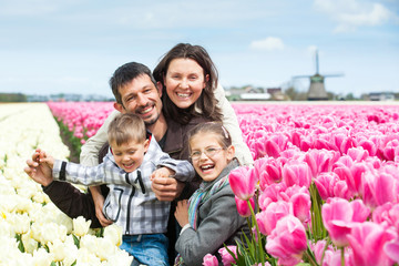 Family having fun on tulips field